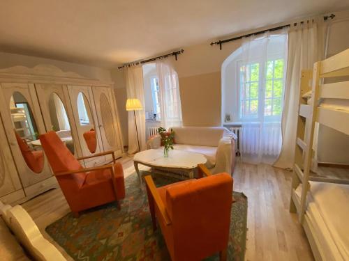 a living room with a couch and a table and chairs at Wasserburg Turow in Glewitz