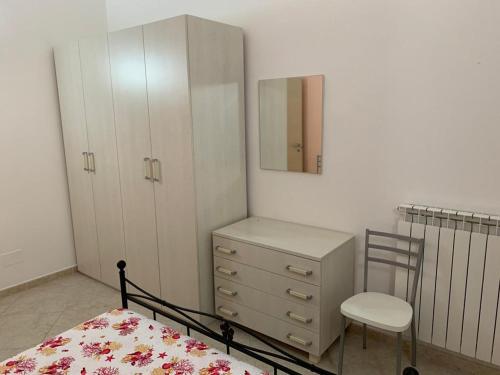 a bedroom with a bed and a dresser and a mirror at Casa sul porto imbarco Tremiti in Termoli
