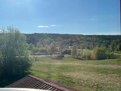 a view of a field with a bridge and trees at FJÄLLSTUGAN 29 in Sälen