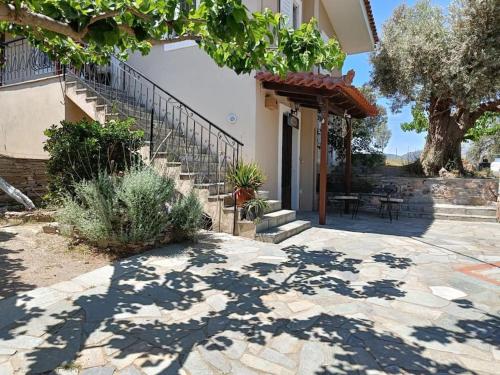 a house with a staircase and a patio at Kato Alonia Home in Áno Váthia