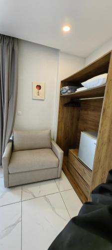 a living room with a couch and a window at TOPAZ three in Siviri