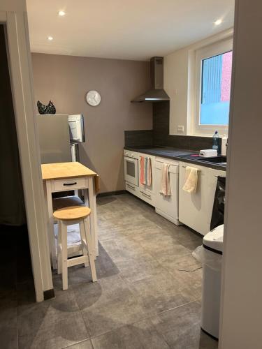 a kitchen with a counter and a table in it at L appart de Cathy in Cahors