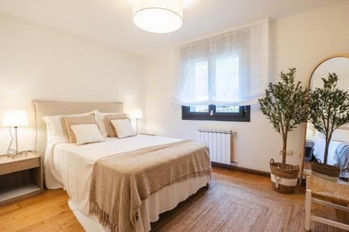 a bedroom with a large bed and a window at Casa Buena Vista in Candás