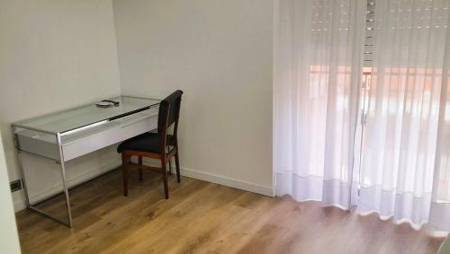 a desk with a chair next to a window at Hotel Plaza Roma in Buenos Aires