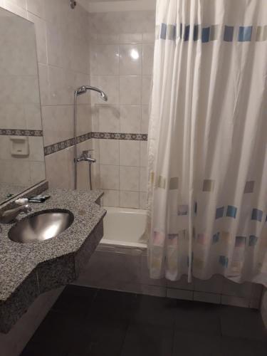 a bathroom with a sink and a shower and a tub at Hotel Plaza Roma in Buenos Aires