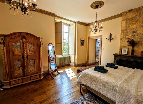 a bedroom with a large bed and a fireplace at Centrally Located Sarlat Apartment with Medieval Town Views in Sarlat-la-Canéda