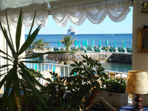 a window with a view of the ocean and a cruise ship at Hotel Helios in Santa Margherita Ligure