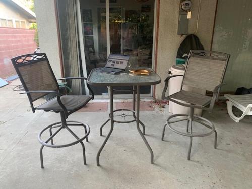 two chairs and a table with a laptop on it at Art Studio(s) at 8509 Fullbright Avenue, Winnetka, CA, USA 91306 in Los Angeles