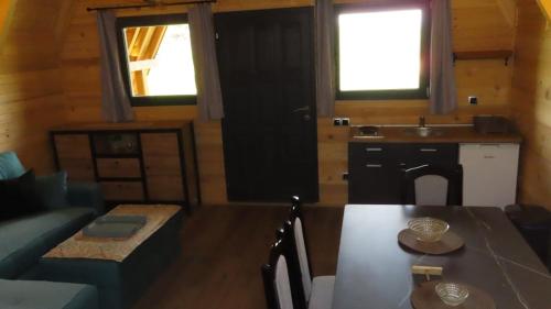 a living room with a table and a kitchen at Peća in Glamoč