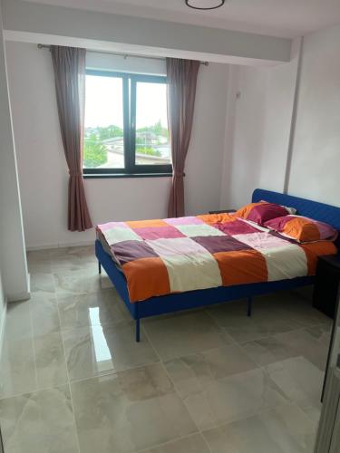 a bed in a room with a window at Everest 33 Ap 4 in Bucharest