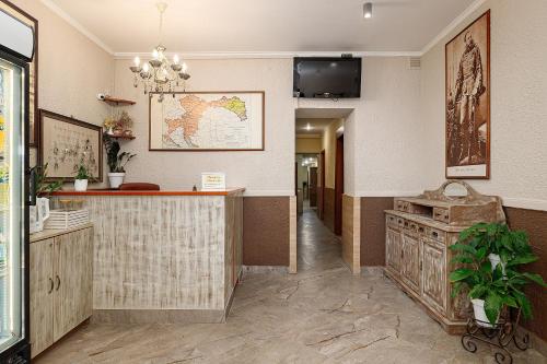 a hotel lobby with a counter and a map on the wall at Готель Кайзер Економ in Lviv
