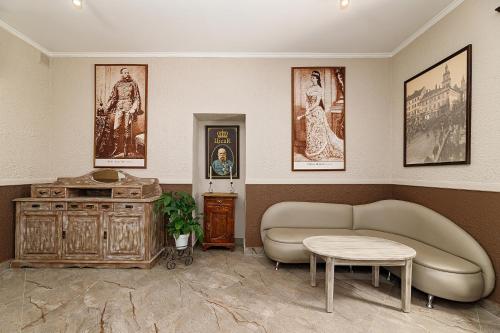 a living room with a couch and a table at Готель Кайзер Економ in Lviv