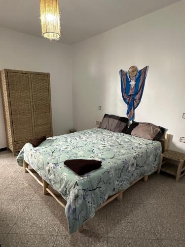a bedroom with a large bed in a room at Sea Surf and Sun in Tamraght Ouzdar