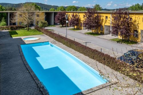 an empty pool in front of a building at Apartment Doky D8 - Lipno Home in Lipno nad Vltavou