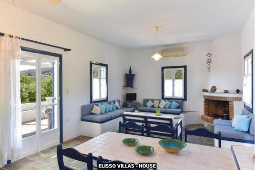 a living room with a couch and a table at Elisso Villas in Platis Gialos
