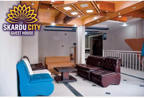 a lobby with a couch and a chair and a table at Skardu city Guest house in Skardu