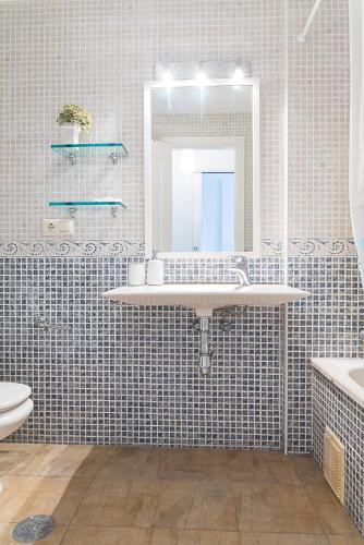a bathroom with a sink and a mirror at AT Tino Casal in Almería