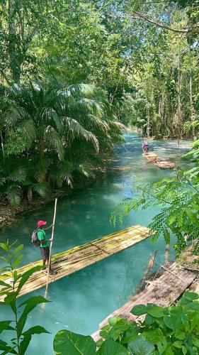 a person standing on a wooden bridge over a river at Reddie Vacation Homes in Windsor