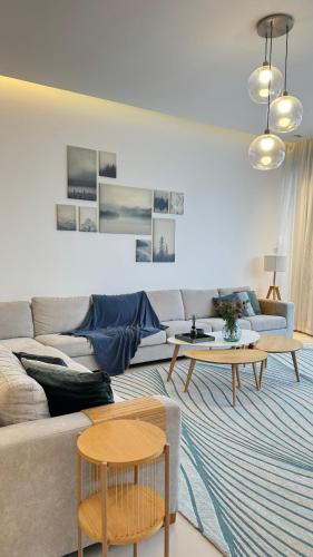 a living room with a couch and two tables at Seascape Villa in Fujairah