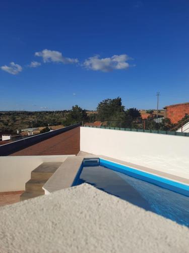 a swimming pool on the roof of a building at Casa da Avó Dada in Torrão