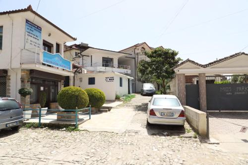 a car parked in a parking lot in front of a building at Guesthouse N&B in Berat