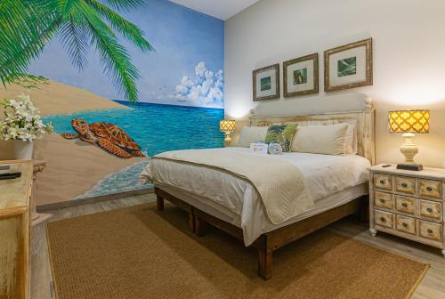 a bedroom with a bed and a painting of the ocean at Palacio Blanco Luxury Villa 3 in La Ventana