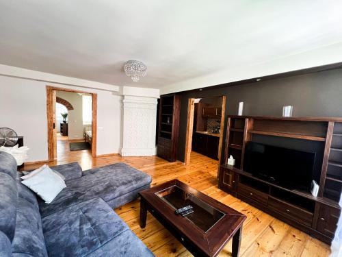 a living room with a couch and a television at Dome square apartment, Old Town in Riga