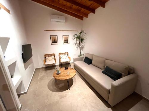 a living room with a couch and a table at The Courtyard Episkopi Guest Houses in Episkopi Lemesou