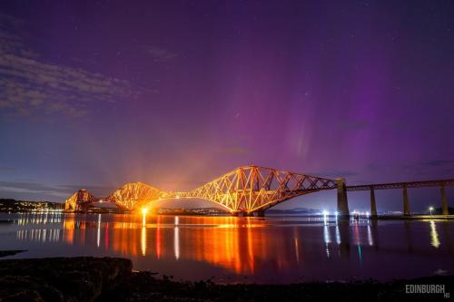 a bridge over the water at night with lights at Lovely Countryside Getaway in Roslin