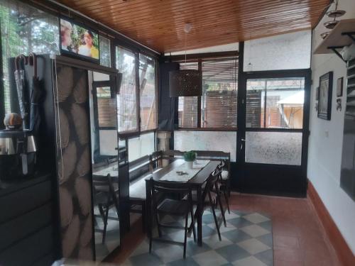 a dining room with a table and chairs and windows at MIDI ROOM terrace wifi carparking in Siófok