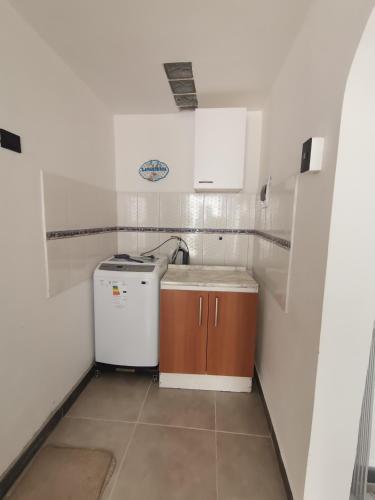 a small kitchen with a sink and a dishwasher at Apart-Hotel Katari in Arica
