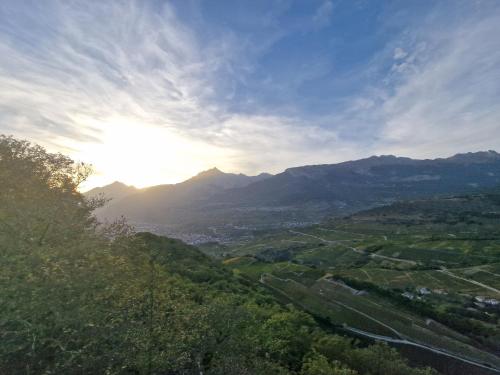 a view of a valley with mountains in the background at Studio Le Carnotzet Tchiko minimum 2 nights Special weekly and monthly prices in Savièse