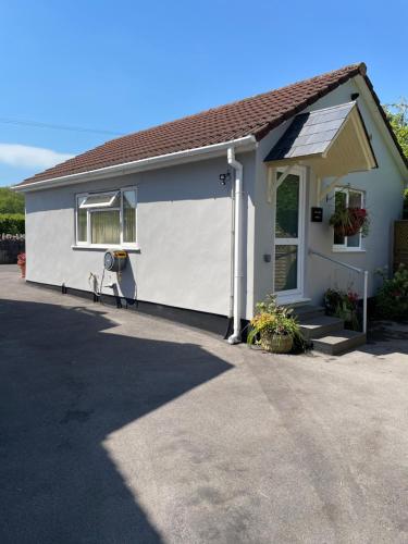a white house with a white garage at Leylands Annexe in East Harptree