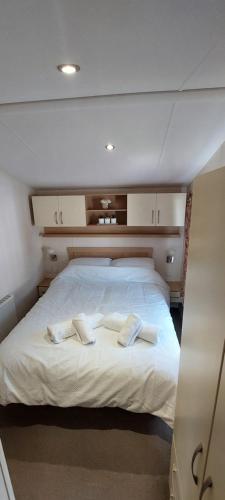 a bed in a room with two pillows on it at Holiday Home - St Austell in St Austell