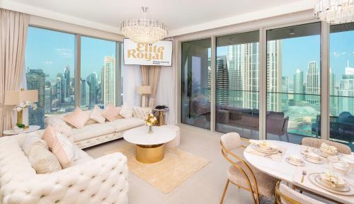 a living room with white furniture and large windows at Elite Royal Apartment - Panoramic with Burj Khalifa & Full Fountain View - High Floor - Patron in Dubai