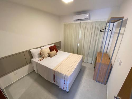 a bedroom with a large bed and a window at Fontes da Pipa by Liiv in Pipa