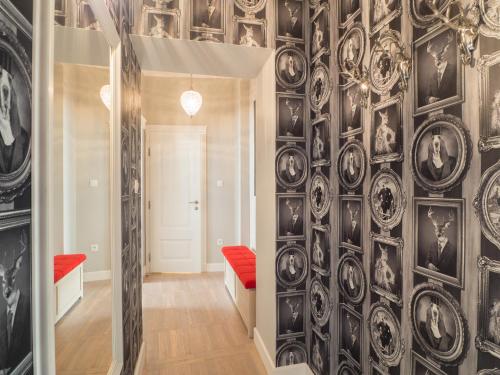 a hallway with a wall covered in plates at Best Apartments Św. Antoniego in Wrocław