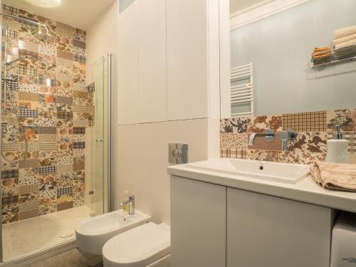 a bathroom with a toilet and a sink and a shower at Best Apartments Św. Antoniego in Wrocław