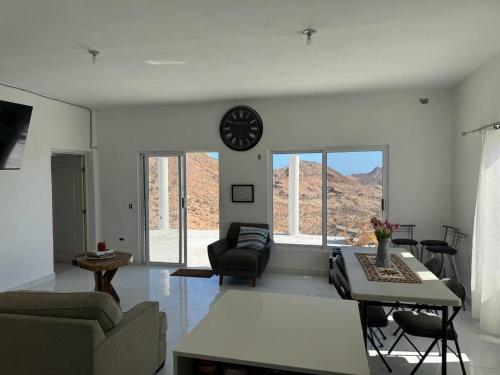 a living room with a clock on the wall at Casa sierra de la Laguna in Salalito