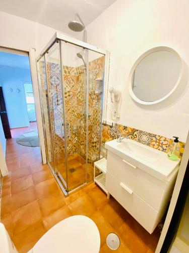 a bathroom with a shower and a sink at Tarifa Townhouse in Tarifa