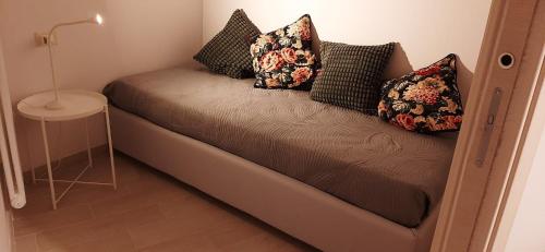 a couch with pillows on it in a room at La casa dei Sogni e dintorni in Cervo