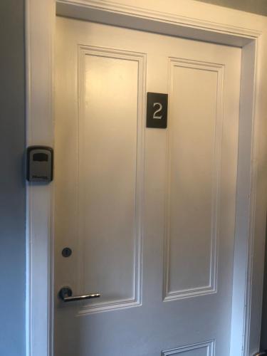 a white door with the number two on it at MacArthur House NC500 in Wick