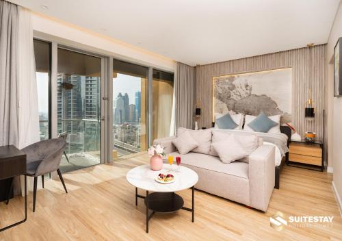 a living room with a couch and a table at Deluxe - Address Dubai Mall - The Residence in Dubai