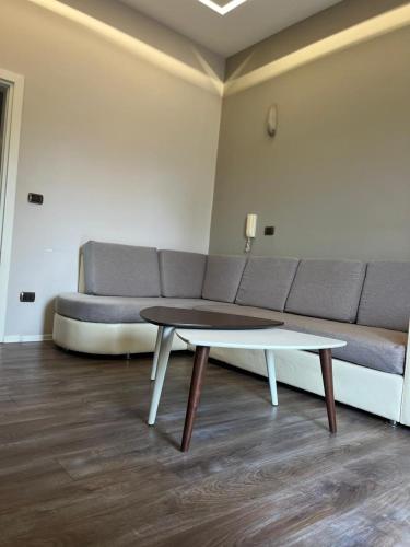 a living room with a couch and a coffee table at Lukas Apartament Vollga Durres in Durrës