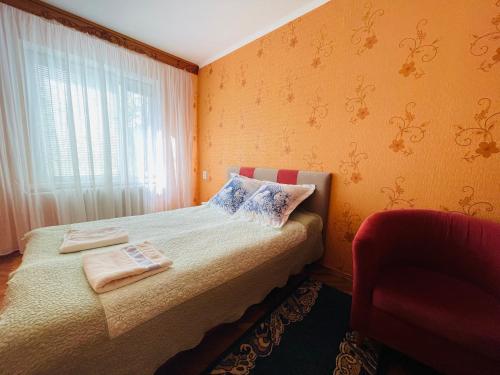 a bedroom with a bed with two towels on it at Premium new Apartament in Chişinău