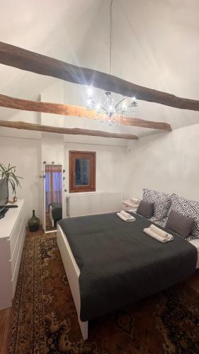 a bedroom with a large bed in a room at Panoráma Vendégház Dunabogdány in Dunabogdány