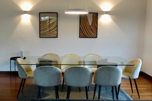 a dining room with a glass table and chairs at 1A119 El Sangar Somio in Gijón