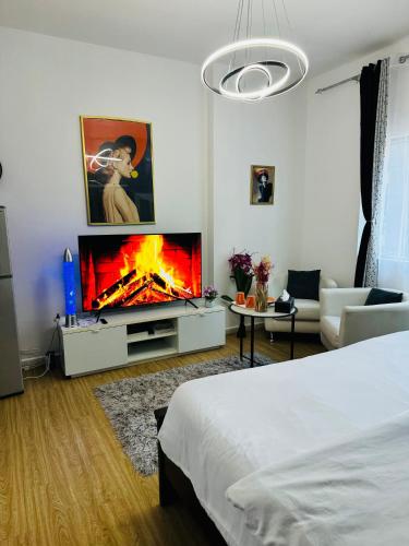 a bedroom with a bed and a tv and a fireplace at DALA MASTER Bedroom En-suite in Sharjah