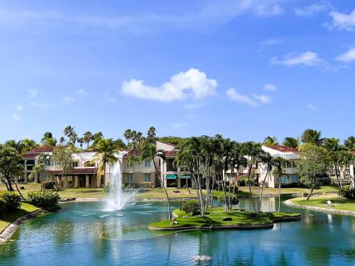 a fountain in the middle of a lake with houses at Villa De Palma -Oceanfront community w generator in Sabana