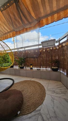 a patio with a large window and a large rug at Résidences C-Irène Angré in Abidjan